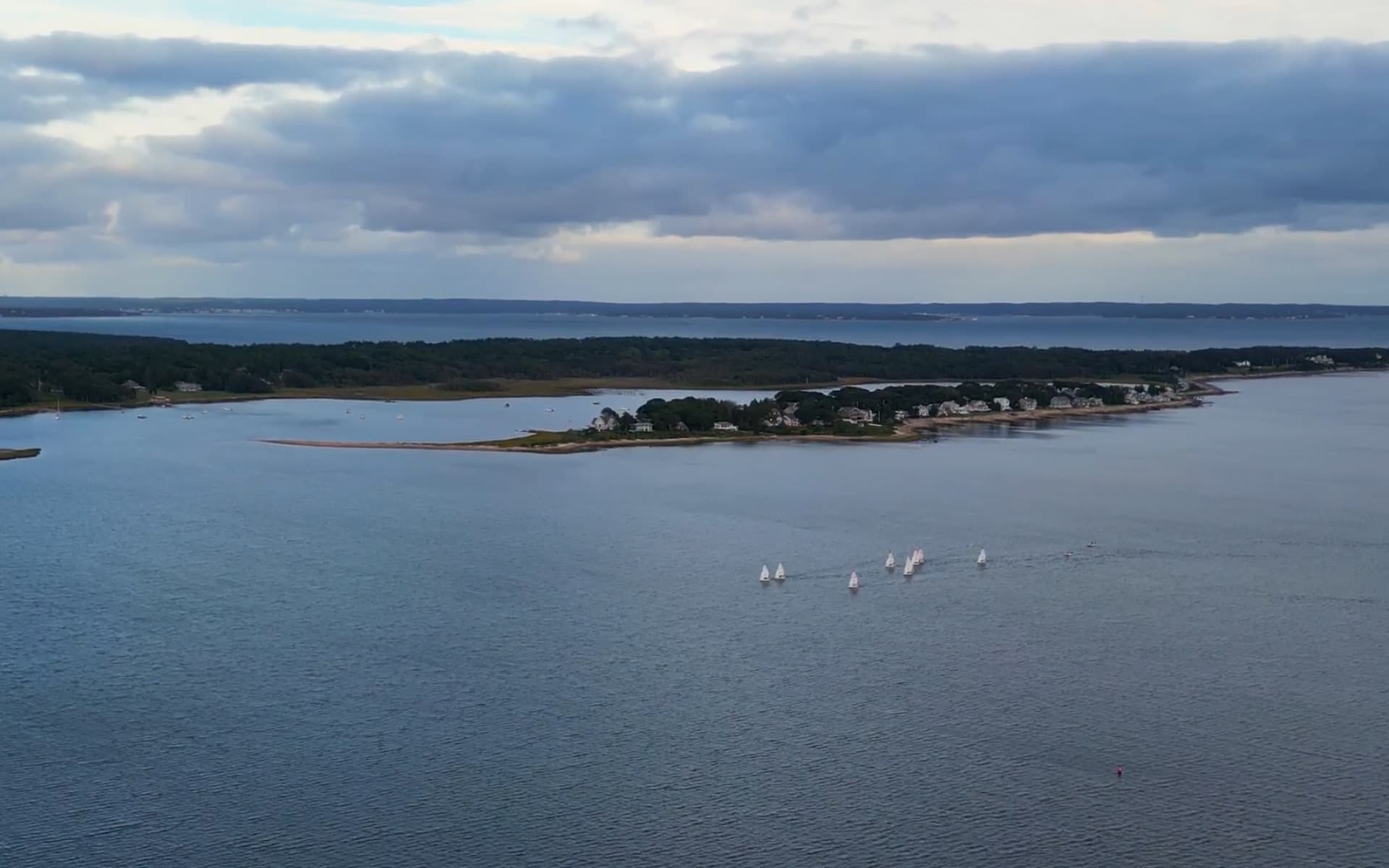 Sailboat on the water along the Buzzards Bay coastline
