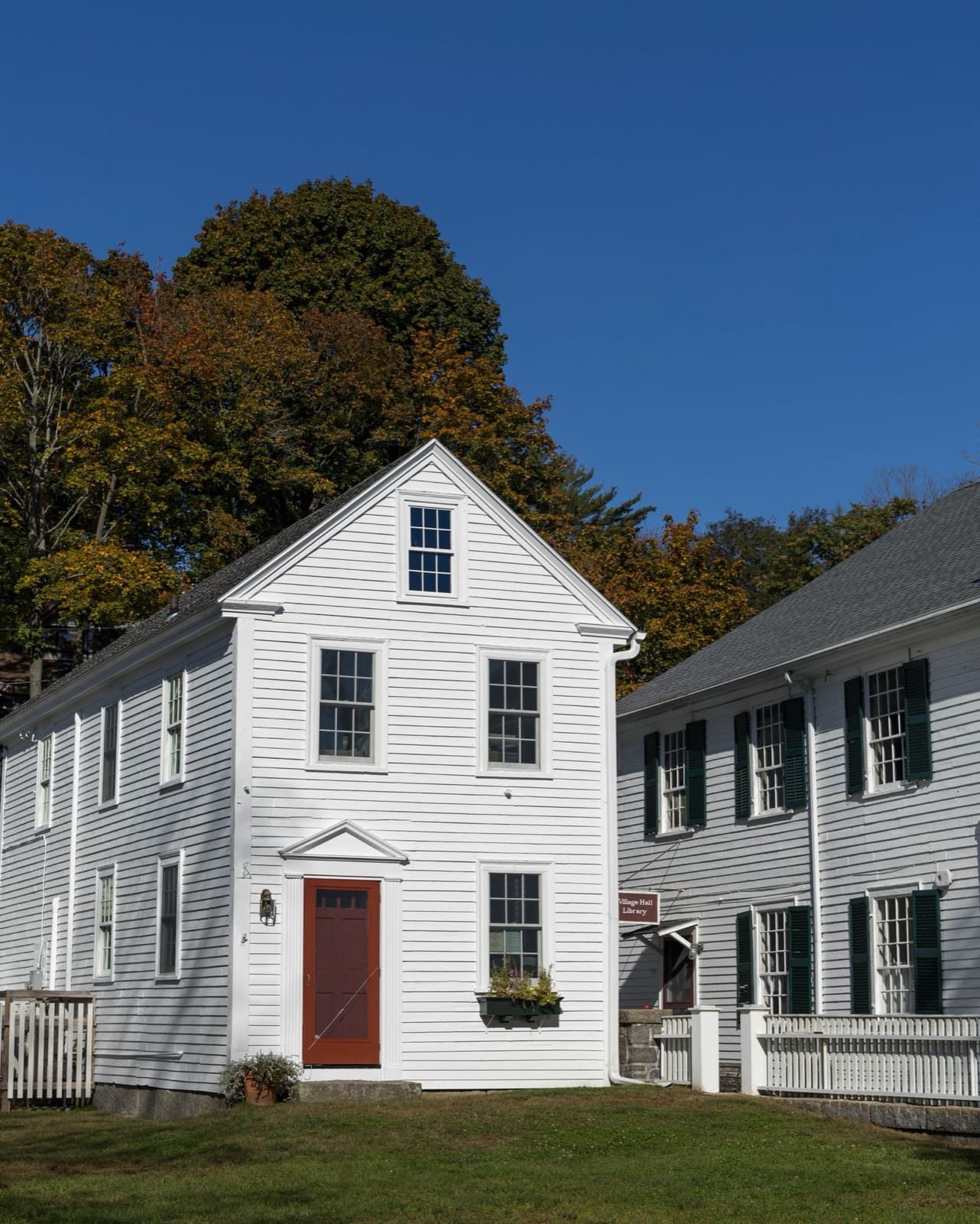 Traditional American white house with shutters in autumn