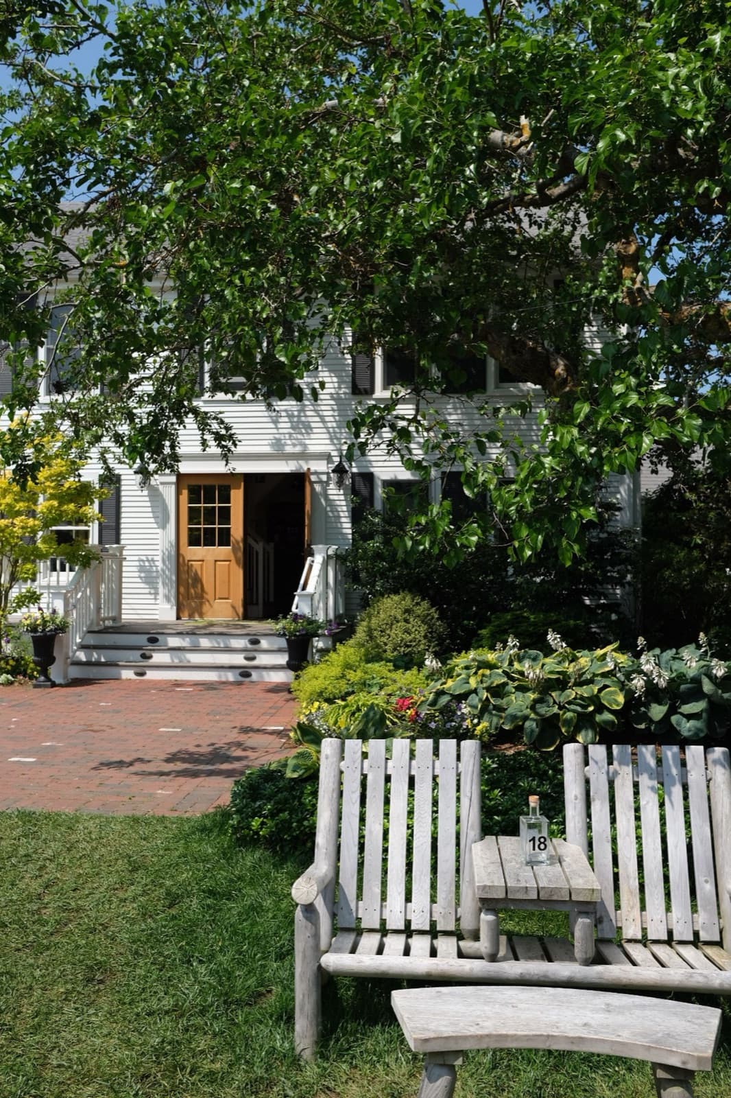New England home with wooden armchairs and garden seating