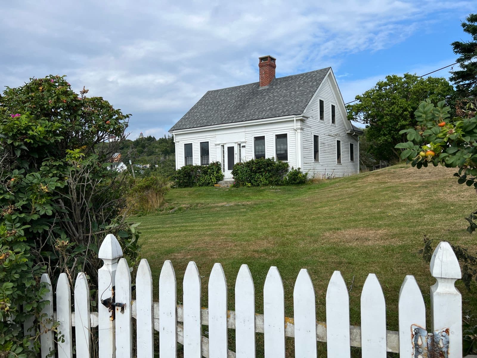 White picket fence cottage in a coastal setting