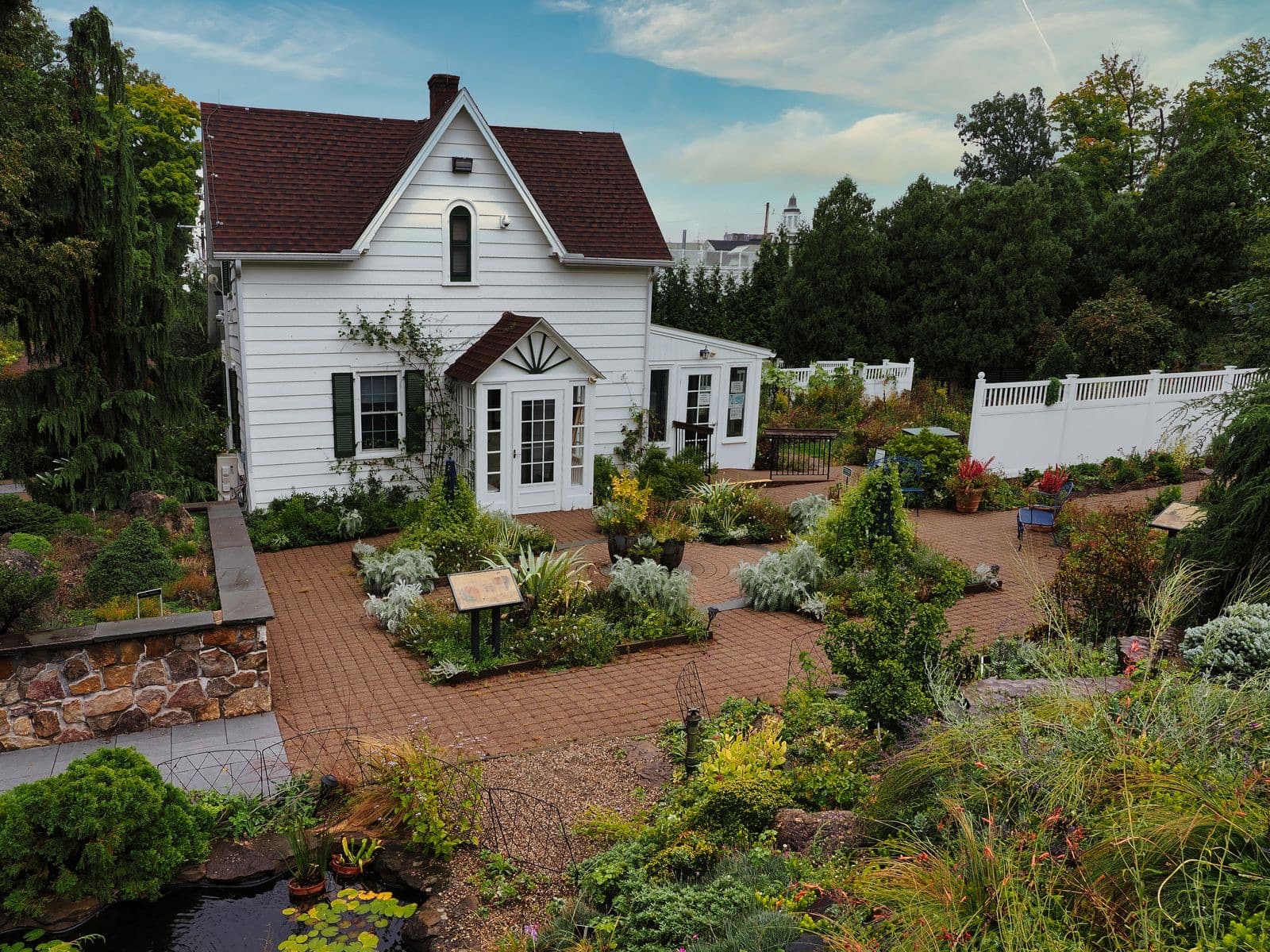 Picturesque white house surrounded by a vibrant garden