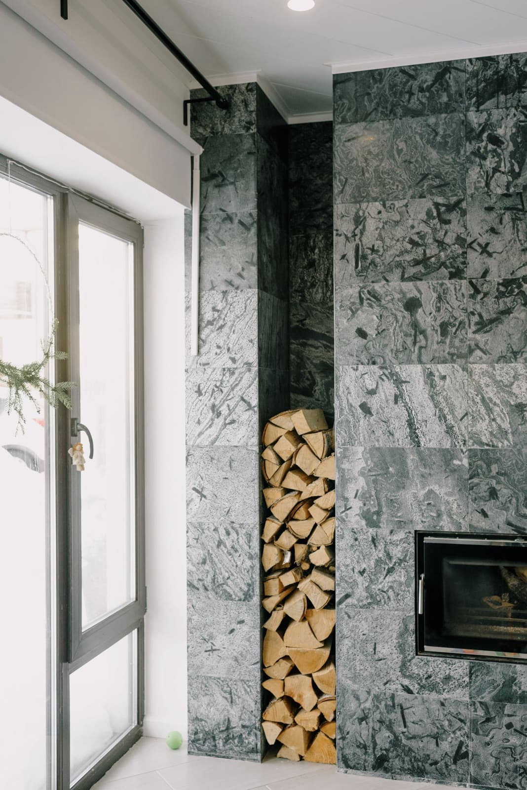 Cozy modern living room with a fireplace and stacked woodpile