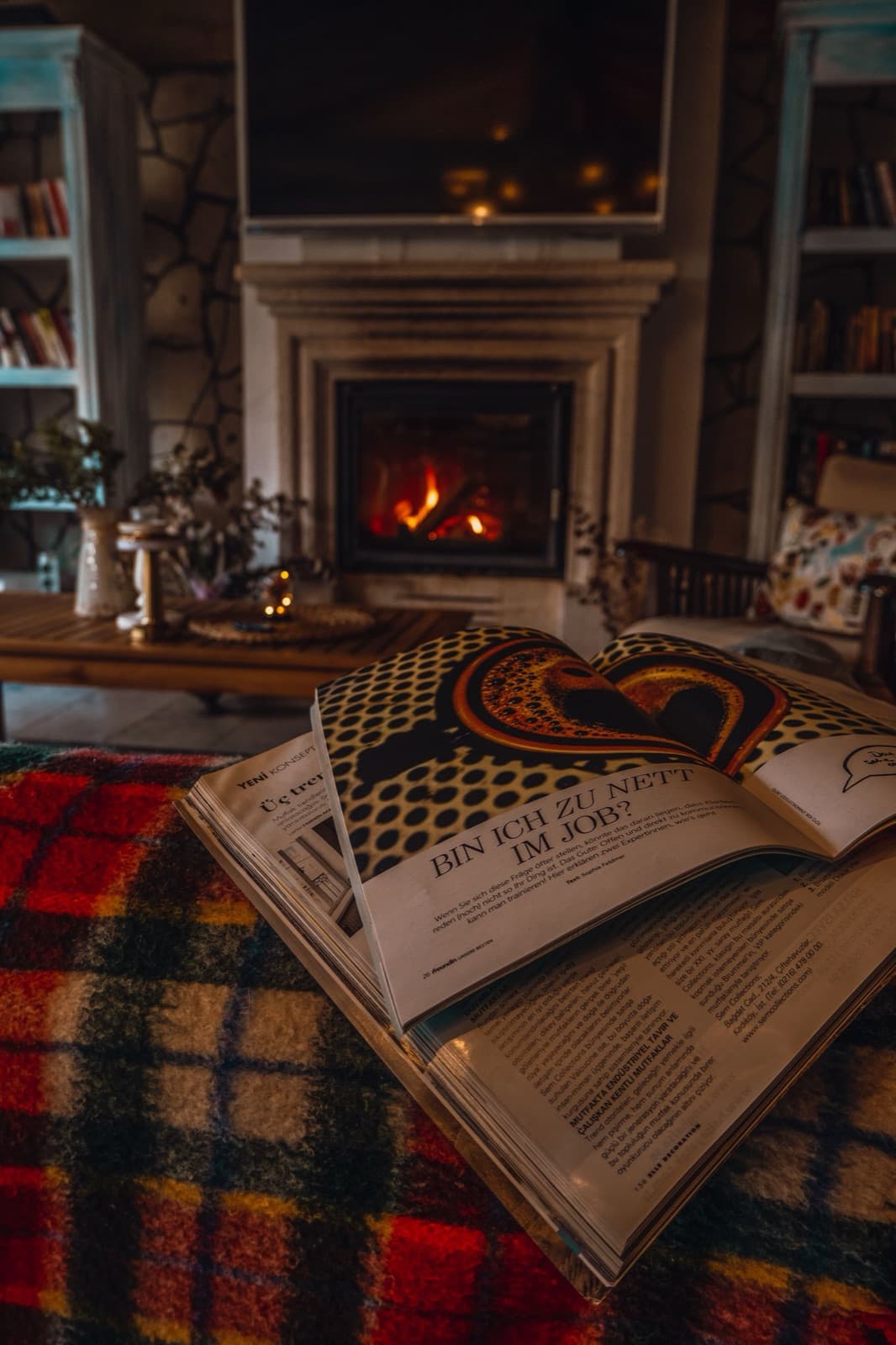 Warm living room with a fireplace and a plaid blanket