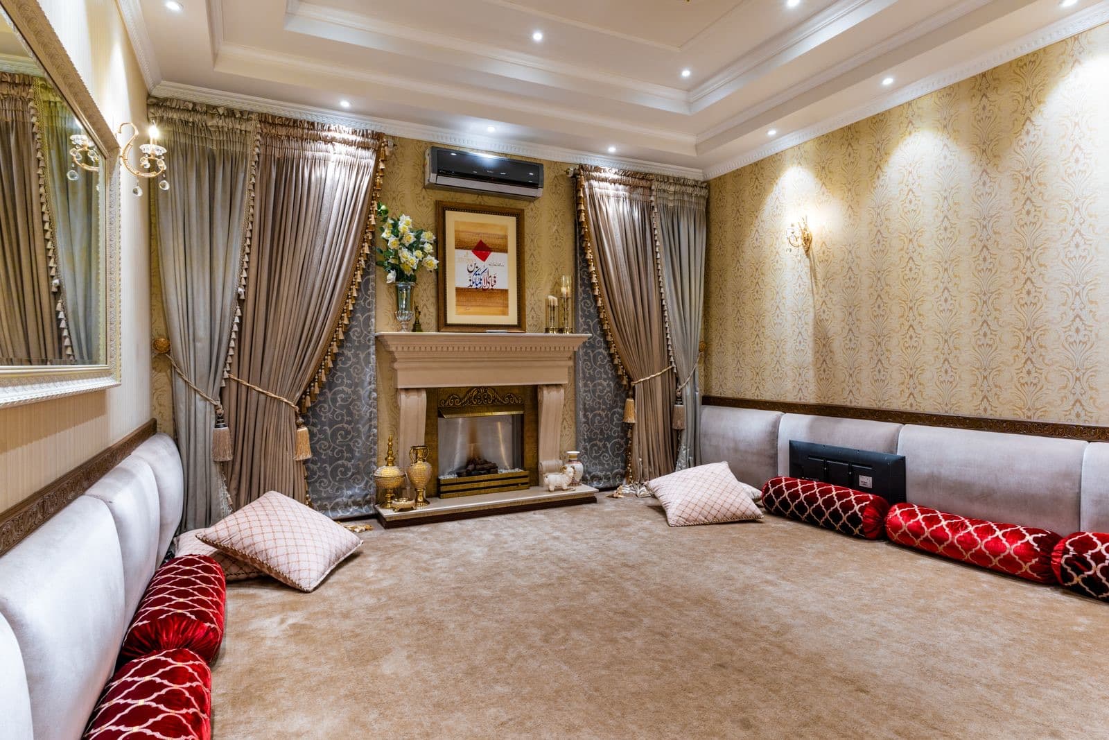 Traditional living room with an ornate fireplace and plush cushions