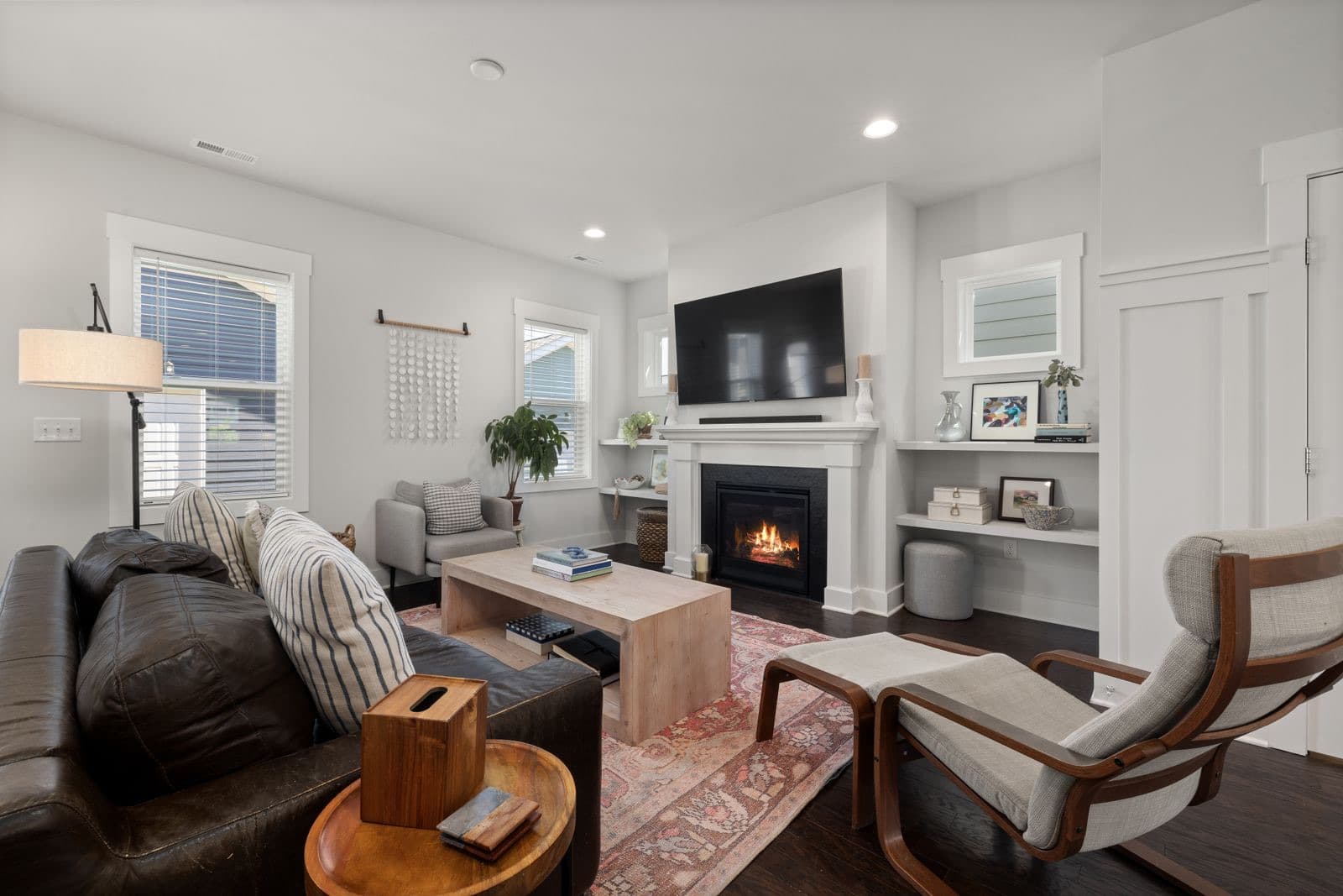 Inviting living room with a leather sofa and a warm fireplace