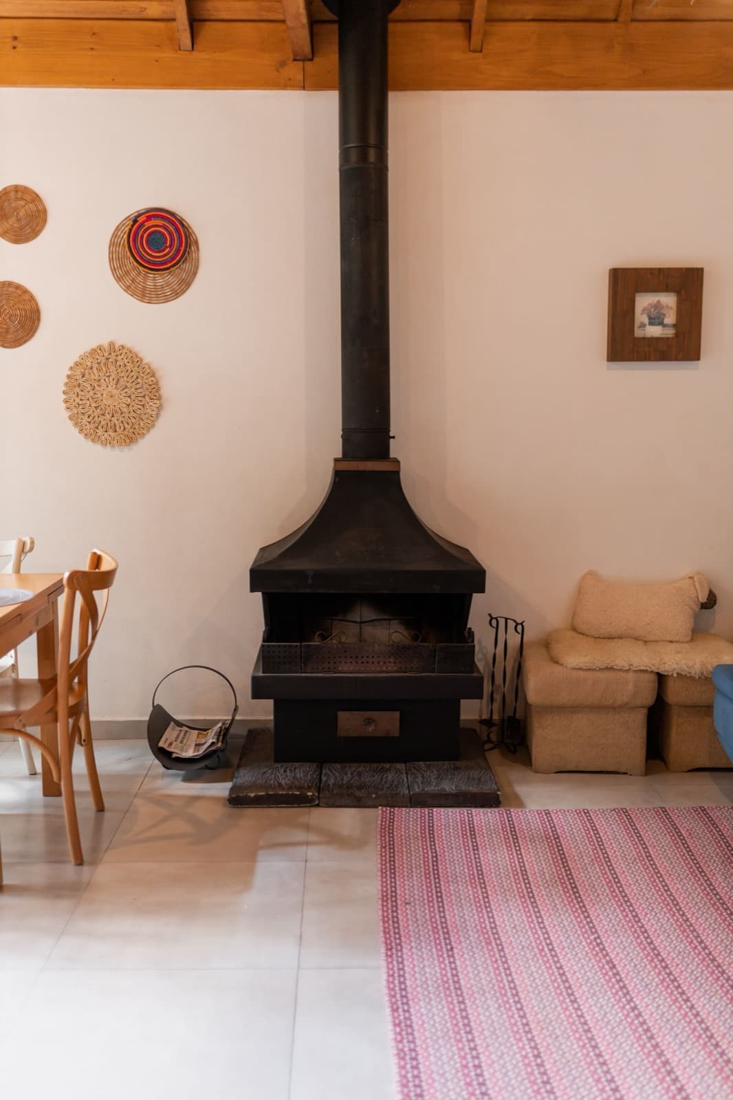 Warm rustic living room featuring a metal fireplace