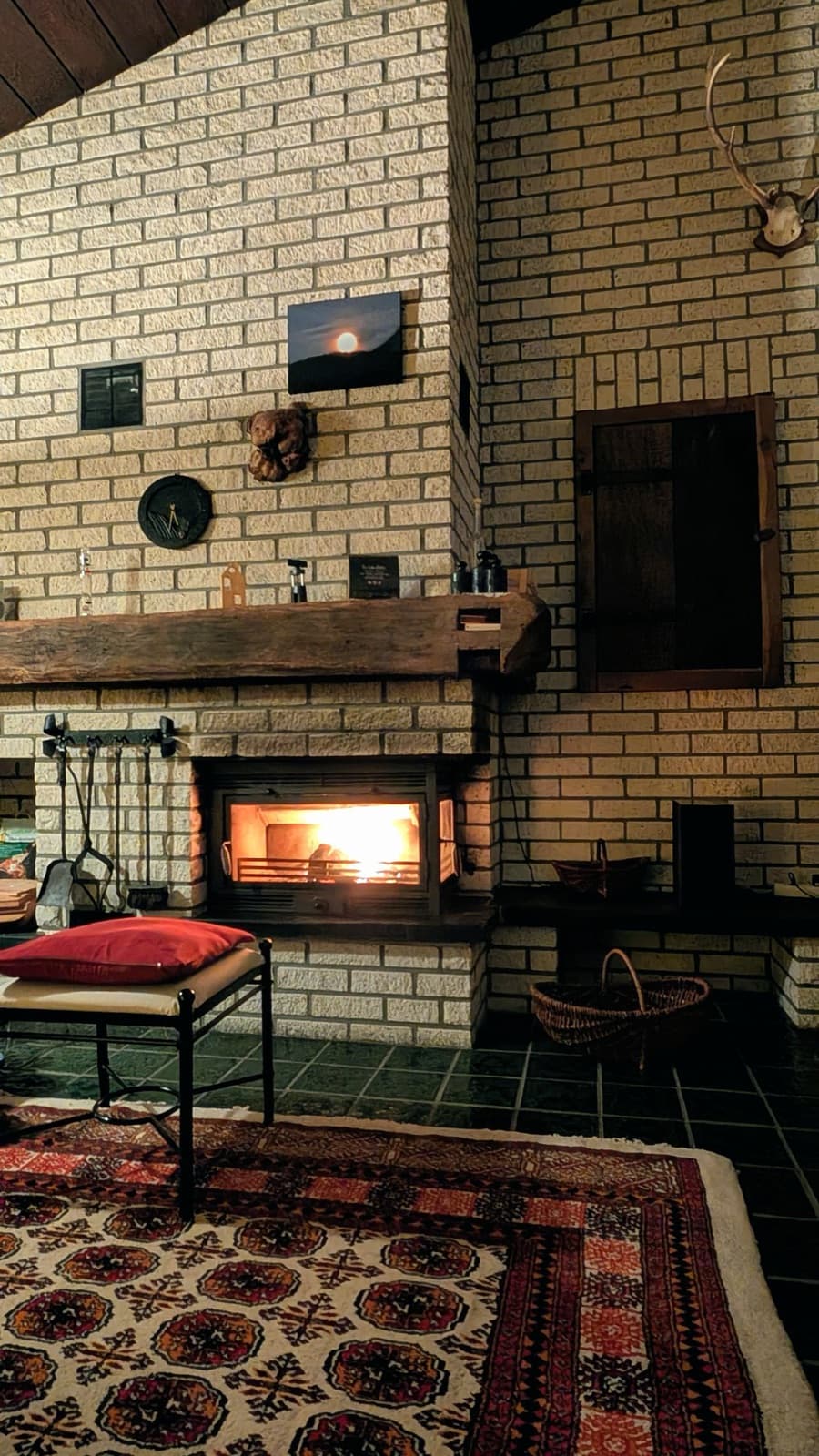 Warm, inviting living room with a lit fireplace