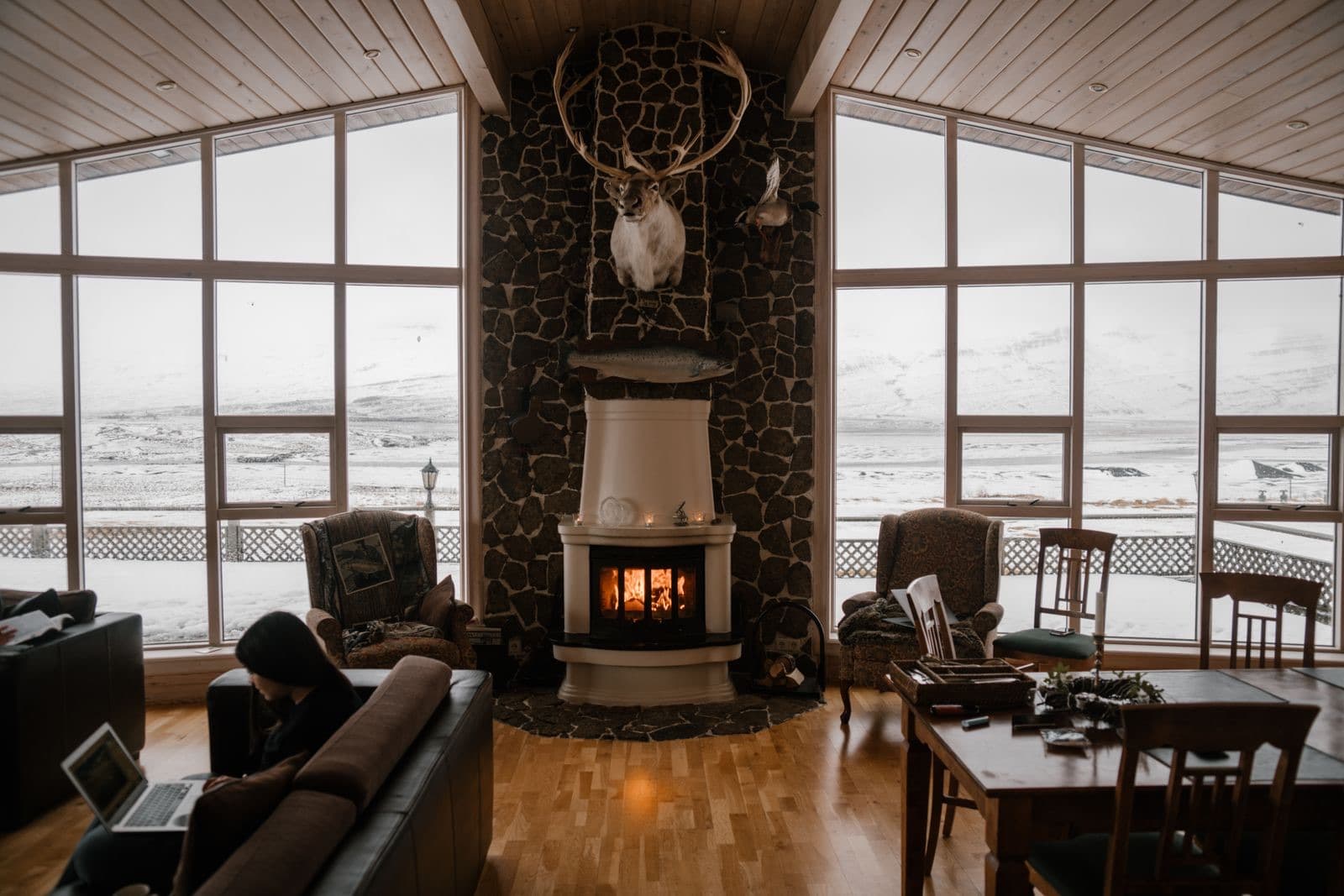 Warm living room with a fireplace and large windows
