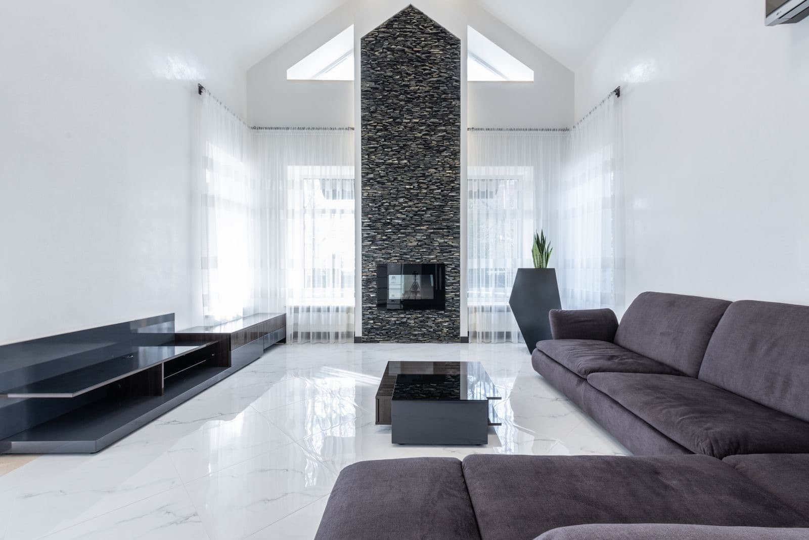 Spacious living room with a comfy couch and fireplace