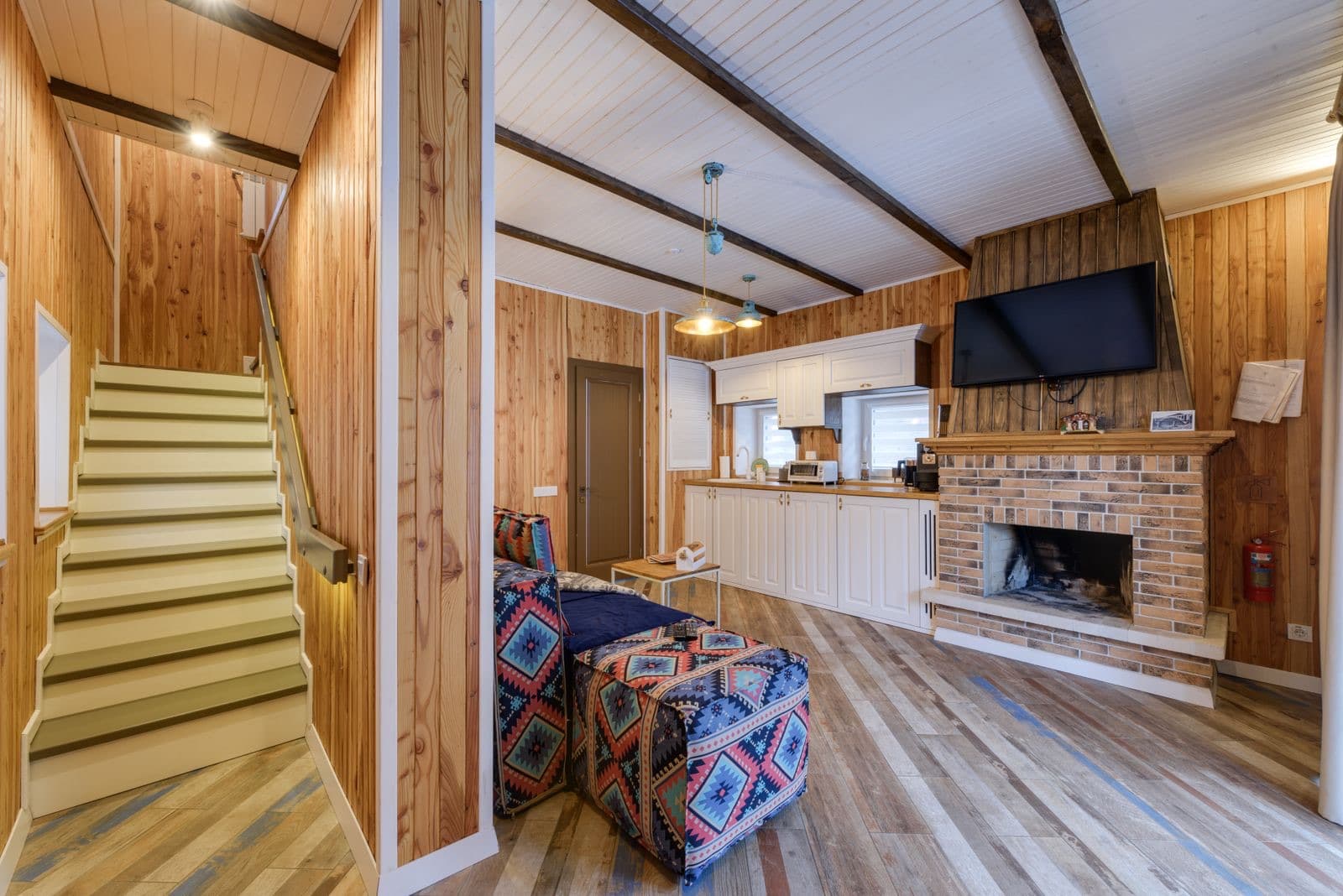 Warm wood-paneled room featuring a fireplace
