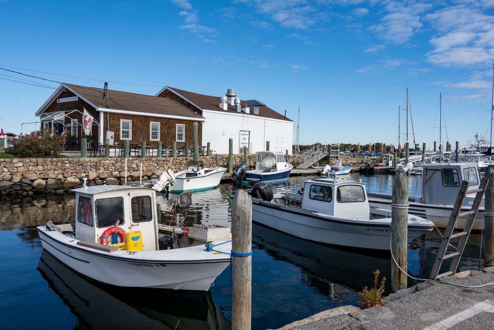 Fishing boats docked at a harbor on a clear fall day