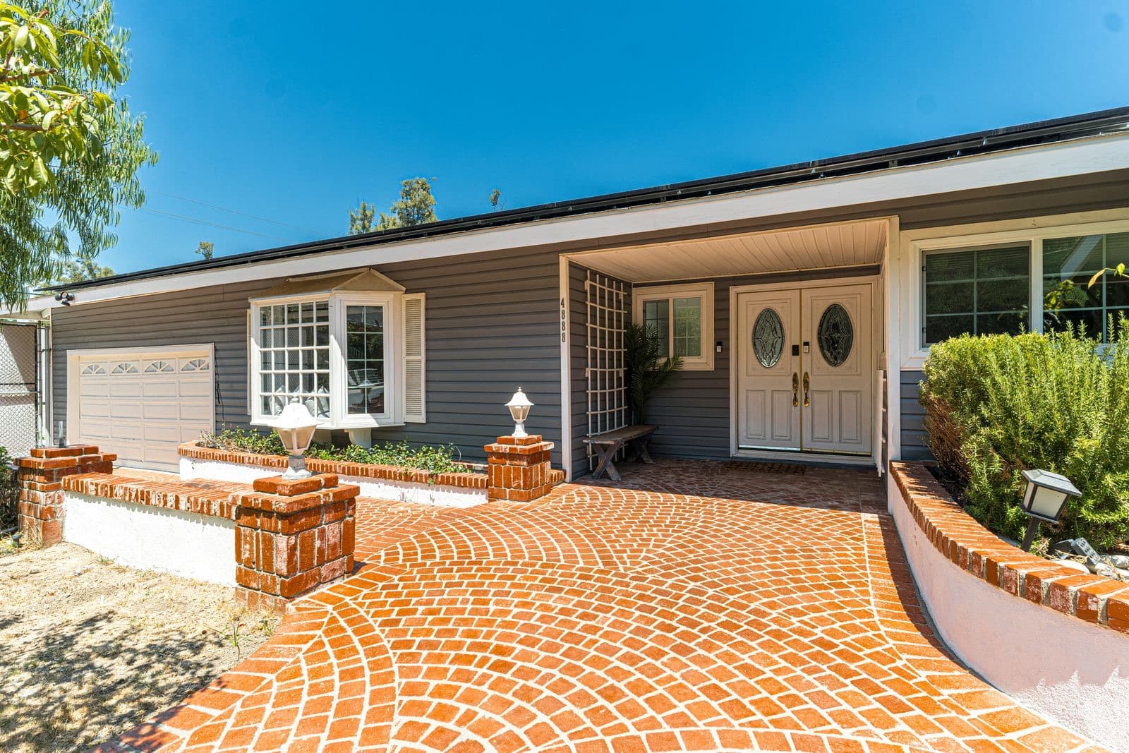 Suburban house with a brick walkway and driveway