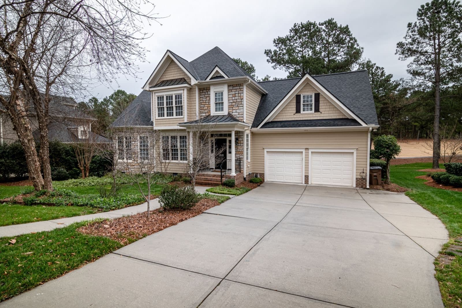 Suburban home with a two-car garage and manicured lawn