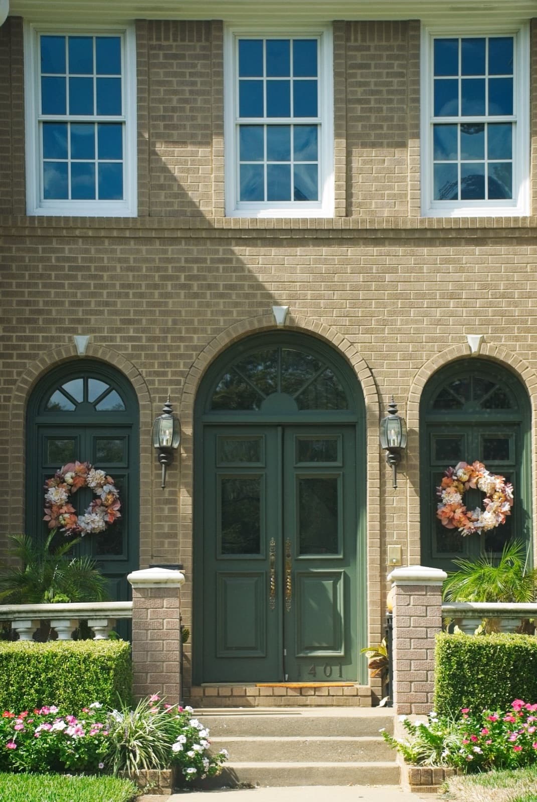 Home exterior with seasonal wreaths and greenery