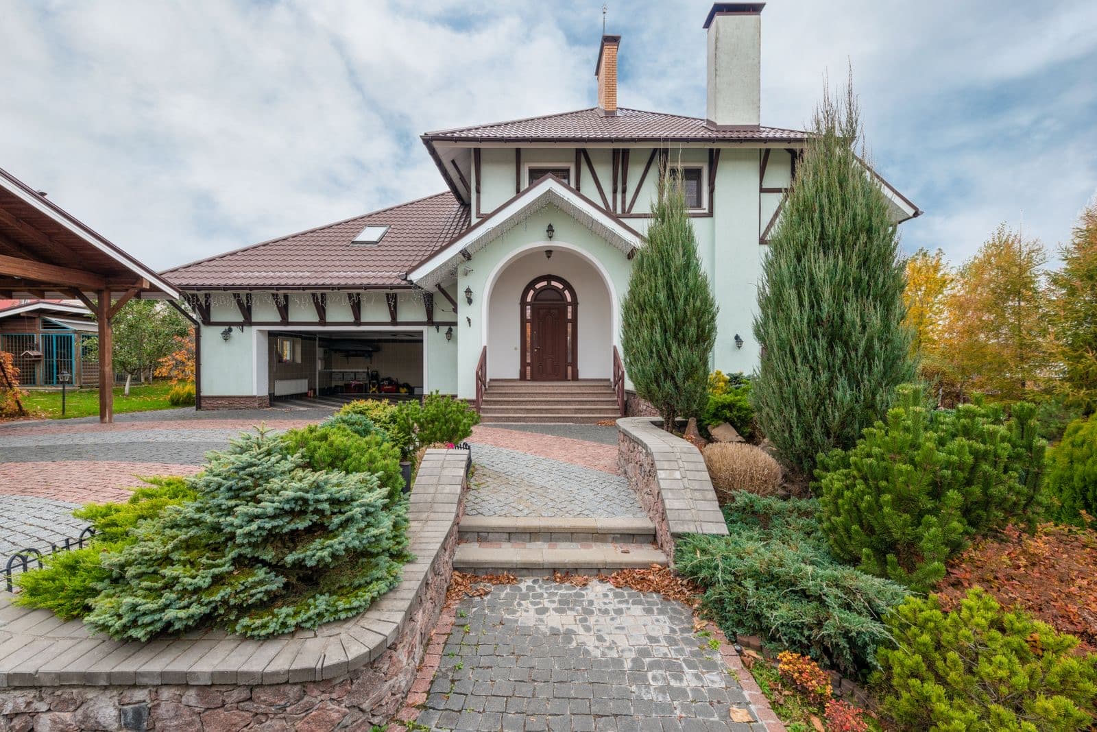 Suburban house with decorative plants and a paved driveway