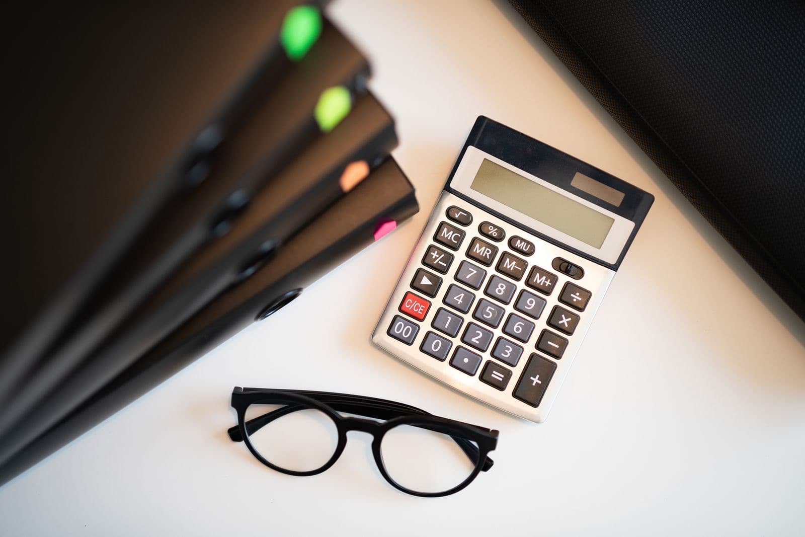 Calculator and folders on an office desk
