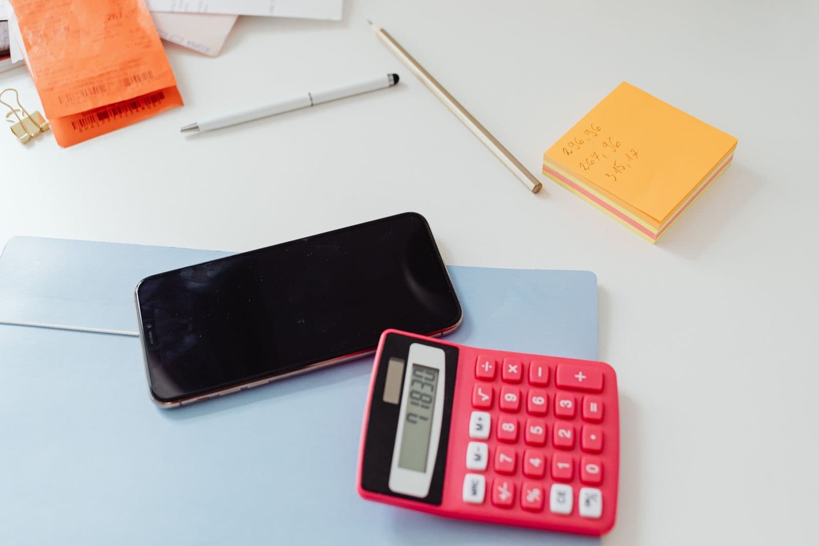 Organized desk with a calculator and sticky notes