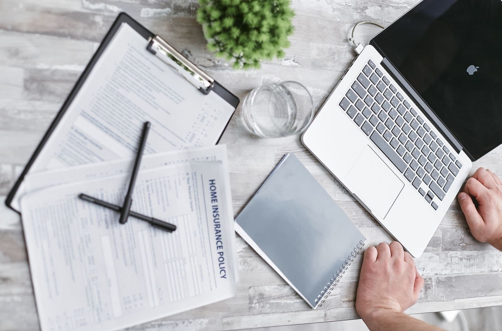 Home paperwork, laptop, and documents on a desk