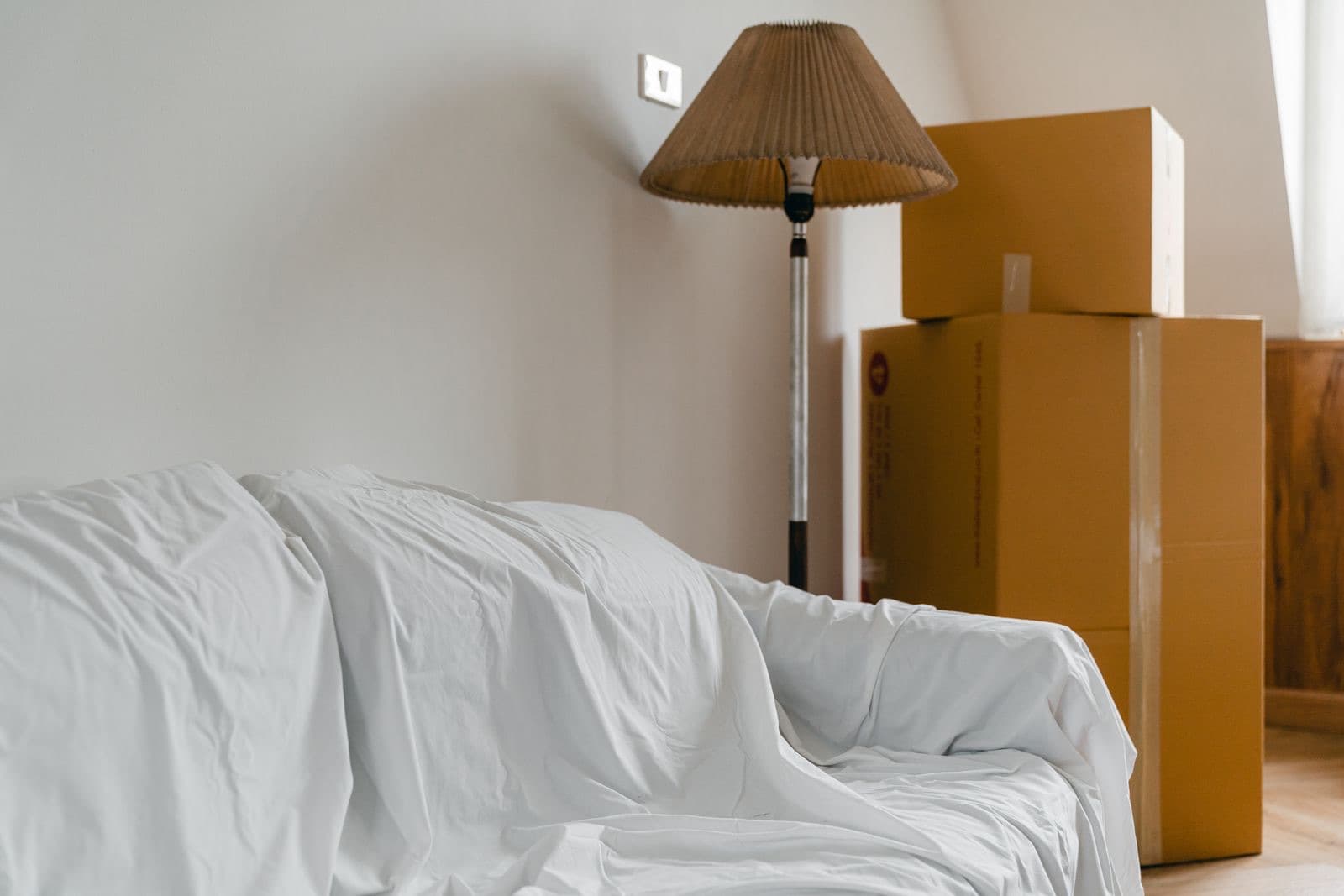 Packed cardboard boxes and furniture in a new house