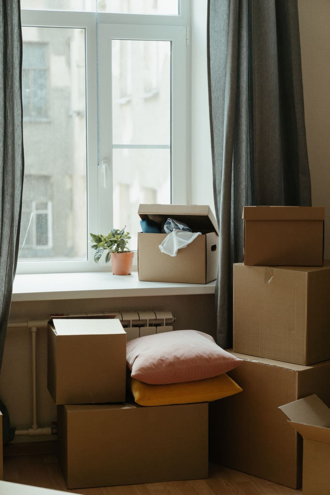 Stack of moving boxes in a sunlit room